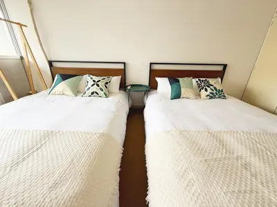 two beds sitting next to each other in a room at The Vera in Tokyo