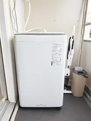 a white refrigerator sitting in a room next to a window at The Vera in Tokyo