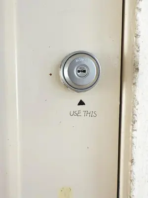 a white door with a use this button on it at The Vera in Tokyo
