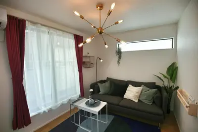 a living room with a couch and a chandelier at SCD155 Spacious Villa in Ikebukuro Suburbs Direct Access to Tokyo's Core Commercial Districts in Tokyo