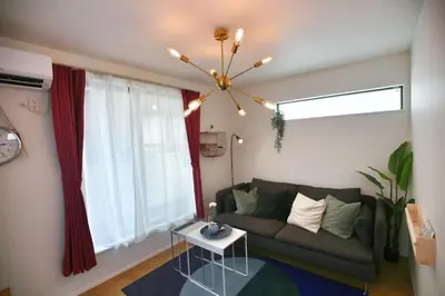 a living room with a couch and a chandelier at SCD155 Spacious Villa in Ikebukuro Suburbs Direct Access to Tokyo's Core Commercial Districts in Tokyo