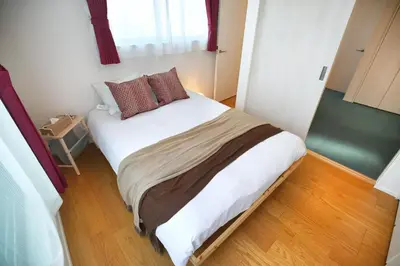 a small bedroom with a large bed in it at SCD155 Spacious Villa in Ikebukuro Suburbs Direct Access to Tokyo's Core Commercial Districts in Tokyo