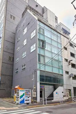 a large gray building on a city street at PREMIER suite Roppongi Crossing Tokyo in Tokyo
