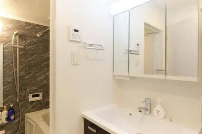 a bathroom with a sink and a mirror and a tub at Cure Skytree by Tranova in Tokyo