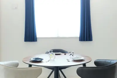 a dining room with a white table and chairs at Cure Skytree by Tranova in Tokyo