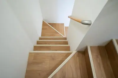 a staircase with white walls and wooden floors at PRIME Asakusa by Tranova in Tokyo