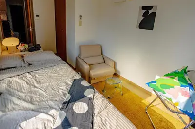 a bedroom with a bed and a chair in it at welcome to shibuya ebisu in Tokyo