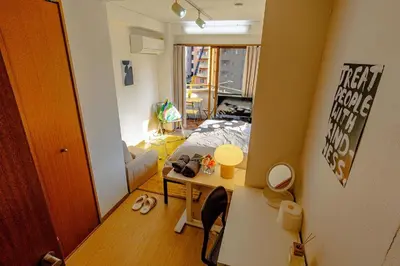 a small room with a bed and a desk in it at welcome to shibuya ebisu in Tokyo