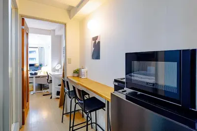 a kitchen with a counter with a bar with stools at welcome to shibuya ebisu in Tokyo