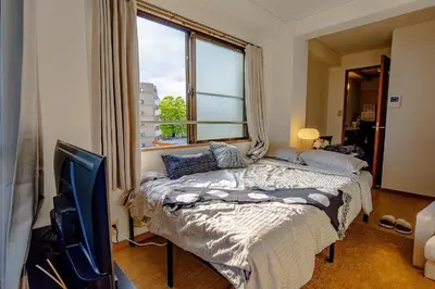 a bedroom with a bed and a large window at welcome to shibuya ebisu in Tokyo