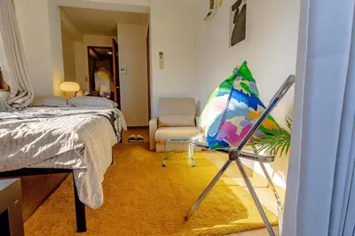 a room with a bedroom with a bed and an umbrella at welcome to shibuya ebisu in Tokyo