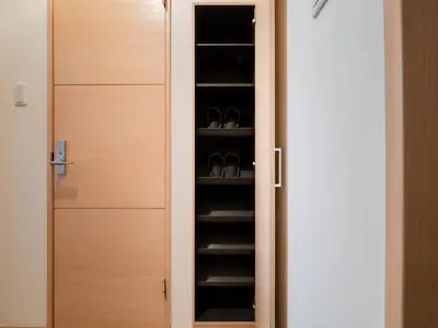 a closet with a door with shoes in it at Ikebukuro 10 min-Family-Friendly Stay-Mobile Wi-Fi&Switch-Net in Tokyo