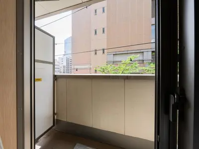 an open window with a view of a building at Ikebukuro 10 min-Family-Friendly Stay-Mobile Wi-Fi&Switch-Net in Tokyo