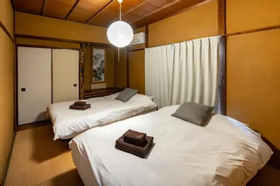 a room with two beds with towels on them at \u4e2d\u677f\u6a4b in Tokyo