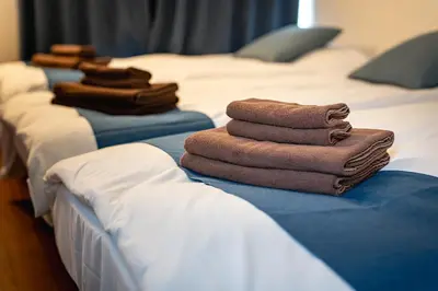 a row of beds with brown towels on them at \u4e2d\u677f\u6a4b in Tokyo