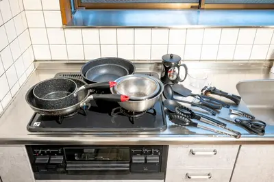 a stove with two pots and pans on it at \u4e2d\u677f\u6a4b in Tokyo