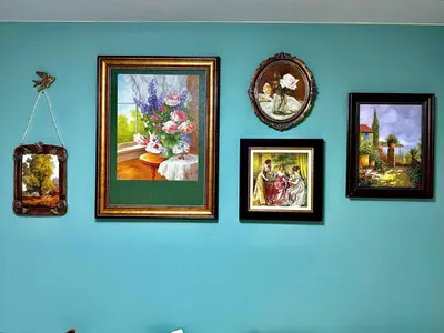 a wall with four framed pictures on a blue wall at G84 Shinjuku center 5 mins to Station, Max 3-\u65b0\u5bbf\u6700\u4e2d\u5fc3 \u6771\u65b0\u5bbf\u7ad95\u5206 \u76f4\u8fbe\u65b0\u5bbf \u6d89\u8c37 \u8868\u53c2\u9053 \u6c60\u888b \u4e0a\u91ce \u4ee3\u4ee3\u6728 \u94f6\u5ea7 \u539f\u5bbf in Tokyo
