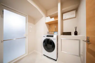 a washing machine in a laundry room with a door at Humming Kinshicho 303-202-301 - Vacation STAY 18969 in Tokyo