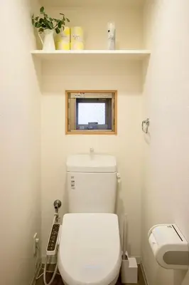 a bathroom with a white toilet with a window at Generous Forest 101 in Tokyo