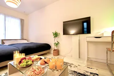 a room with a bed and a table with food on it at Generous Forest 101 in Tokyo