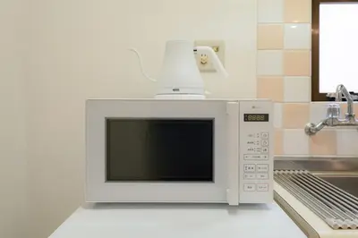 a microwave oven sitting on top of a kitchen counter at untio residence HATAGAYA North in Tokyo