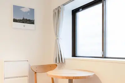 a room with a table and a window at untio residence HATAGAYA North in Tokyo