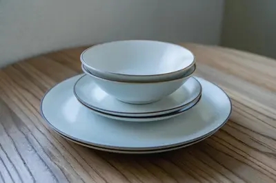 a stack of bowls and plates on a table at untio residence HATAGAYA North in Tokyo