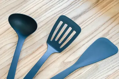four plastic spoons and a spatula on a wooden table at untio residence HATAGAYA North in Tokyo