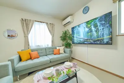 a living room with a couch and a table at Sumida A Cozy Entire House Sleeps 8 Near Station Tokyo Skytree Asakusa in Tokyo