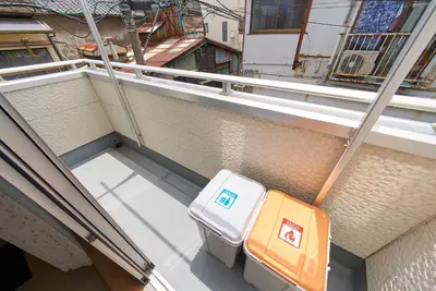 two pieces of luggage sitting on the side of a building at Sumida A Cozy Entire House Sleeps 8 Near Station Tokyo Skytree Asakusa in Tokyo