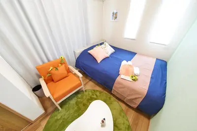 a small room with a bed and a chair at Sumida A Cozy Entire House Sleeps 8 Near Station Tokyo Skytree Asakusa in Tokyo