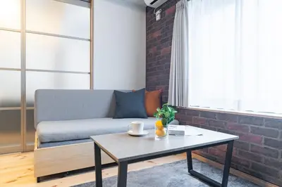 a living room with a couch and a coffee table at \u30f4\u30a3\u30f3\u30c6\u30fc\u30b8CiTY\u4e21\u56fd in Tokyo