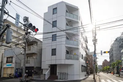 a white building on the corner of a street at \u30f4\u30a3\u30f3\u30c6\u30fc\u30b8CiTY\u4e21\u56fd in Tokyo