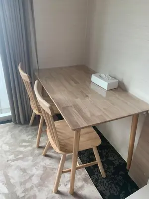 a wooden table with two chairs and a box of tissues at Li Tokyo otta in Tokyo
