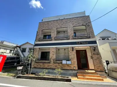 a brick building with a sign that reads be pray at Li Tokyo otta in Tokyo