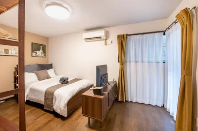 a bedroom with a bed and a television in it at Livecore -Apartment hotel- in Tokyo