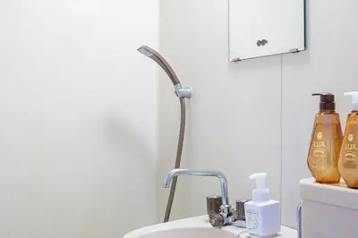 a bathroom with a sink and a faucet at Livecore -Apartment hotel- in Tokyo
