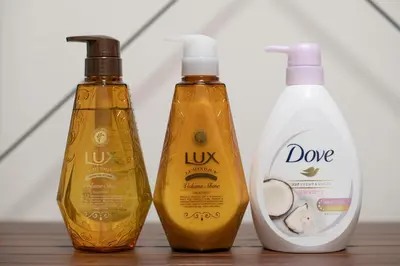 three bottles of laundry deteriments sitting on a table at Livecore -Apartment hotel- in Tokyo