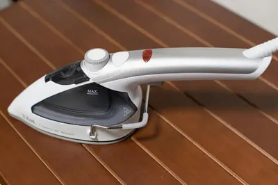 a iron sitting on top of a wooden table at Livecore -Apartment hotel- in Tokyo