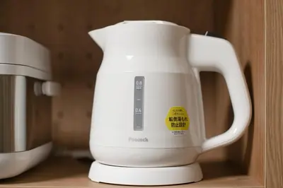 a white jug sitting on a shelf next to a mixer at Livecore -Apartment hotel- in Tokyo