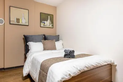 a bedroom with a bed with two pairs of shoes on it at Livecore -Apartment hotel- in Tokyo