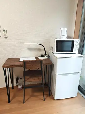 a microwave oven sitting on top of a table at Senju 101, Cozy Tokyo Studio in Tokyo
