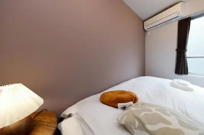 a room with a bed with a stuffed animal on it at TS Yoyogi by Tranova in Tokyo