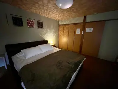 a bedroom with a large bed in a room at Imperial Tateishi in Tokyo