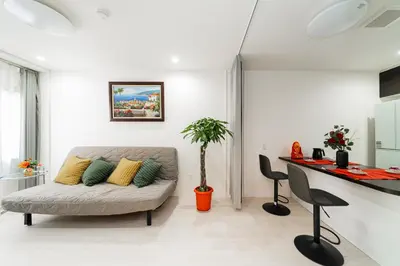 a living room with a couch and a table at Nine Lane Nippori in Tokyo
