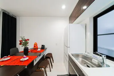a kitchen with a long table and a sink at Nine Lane Nippori in Tokyo