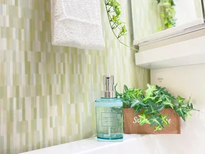 a bottle of soap sitting on a counter next to a plant at \u30df\u30ce\u30eb\u30d0\u91d1\u753a in Tokyo