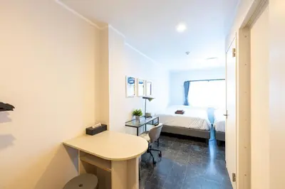a small room with a bed and a desk at Tune Inn Residence Nihonbashi in Tokyo
