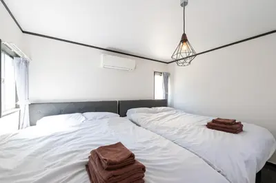 a bedroom with two beds with towels on them at Tune Inn Residence Nihonbashi in Tokyo