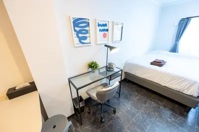 a small bedroom with a desk and a bed at Tune Inn Residence Nihonbashi in Tokyo